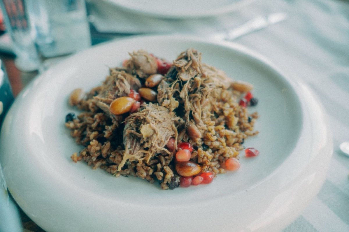 Djaj bil Freekeh — Chicken with Roasted Green Wheat — A whole chicken simmered in aromatic spiced stock until falling off the bone, served over smoky roasted green
