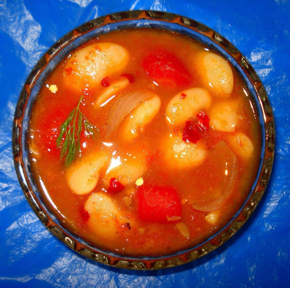Fasoulia bil Zeit — White beans simmered low and slow with ripe tomatoes, garlic, olive oil, and a curl of lemon