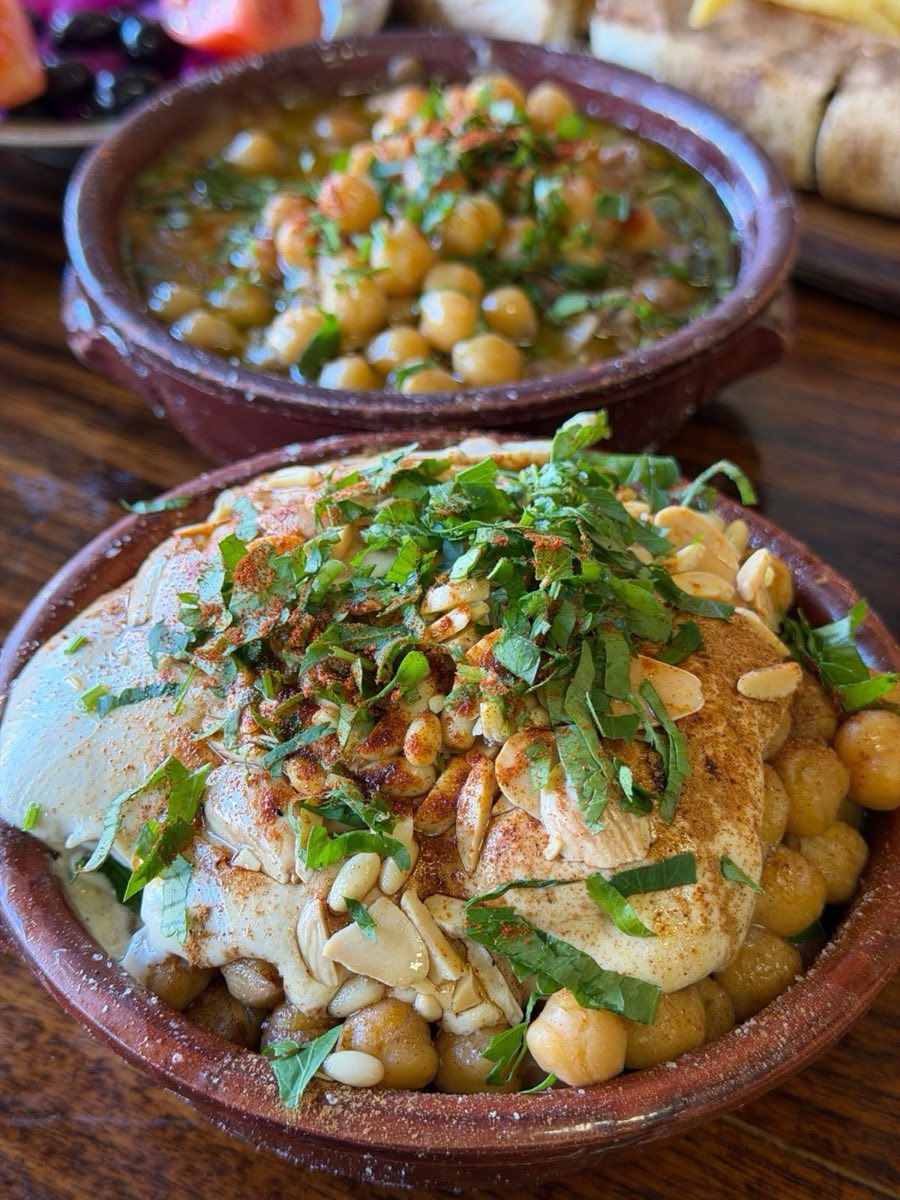 Fatteh — Layers of toasted pita bread soaked in hot chickpea broth, buried under garlicky tahini-yogurt sauce, crowned