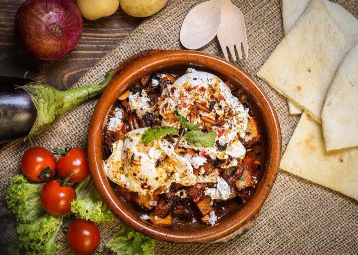 Fattet al-Batinjan — Layers of toasted pita, fried eggplant, and tomato sauce, smothered under a garlicky tahini-yogurt sauce and