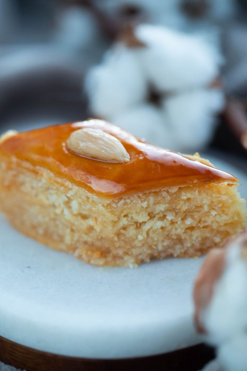 Harisseh al-Hilweh — Lebanese semolina and coconut cake drenched in sugar syrup and topped with whole blanched almonds