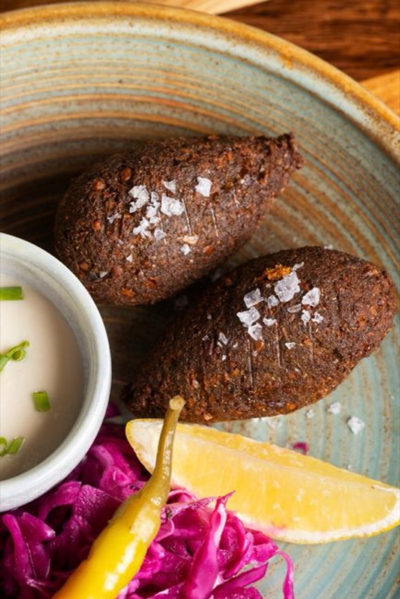 Idlibi Kibbeh — Crispy fried kibbeh shells filled with spiced lamb, onions, and pine nuts