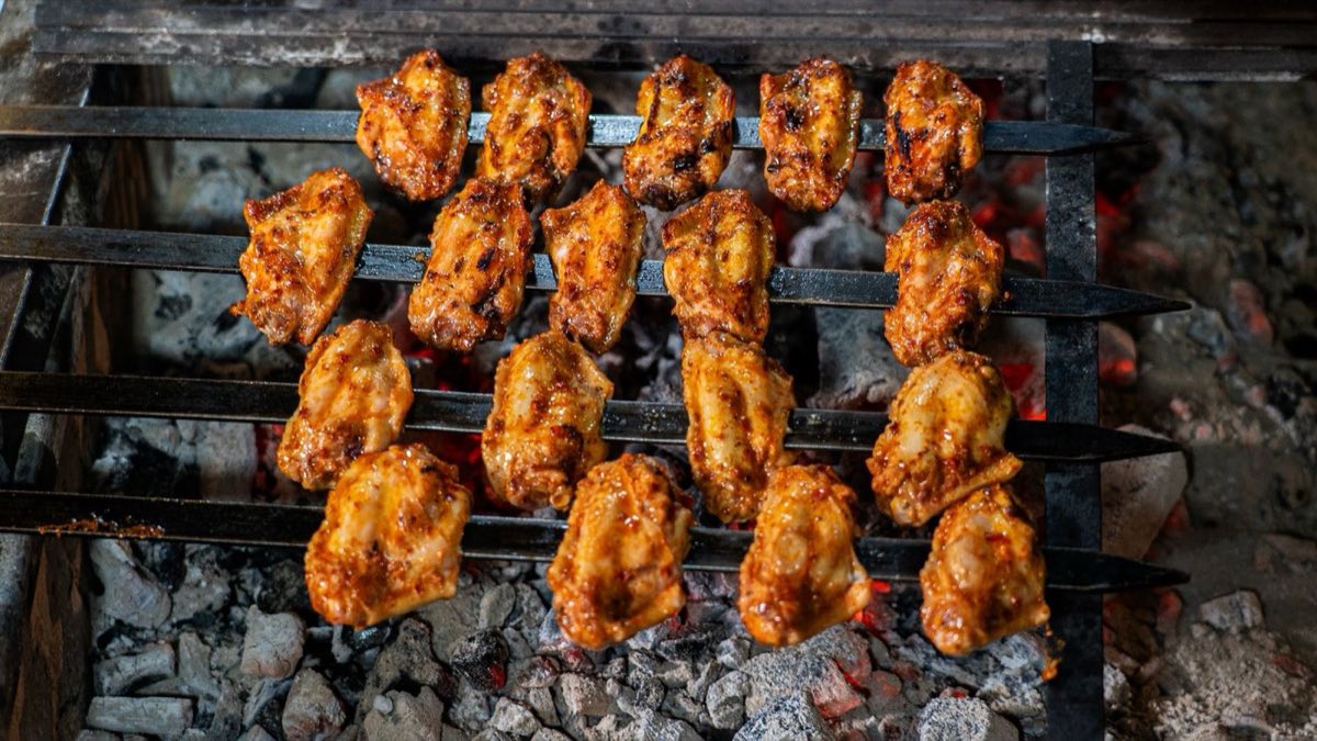 Jawaneh Djaj — Chicken wings marinated overnight in a punishing amount of garlic and lemon, then grilled over charcoal until