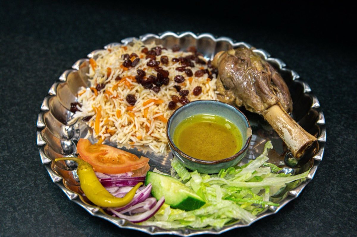 Kabsa Idlibi — Spiced Rice with Lamb and Dried Fruit — Slow-cooked lamb over basmati rice perfumed with cardamom, dried limes, rose water, and saffron, finished