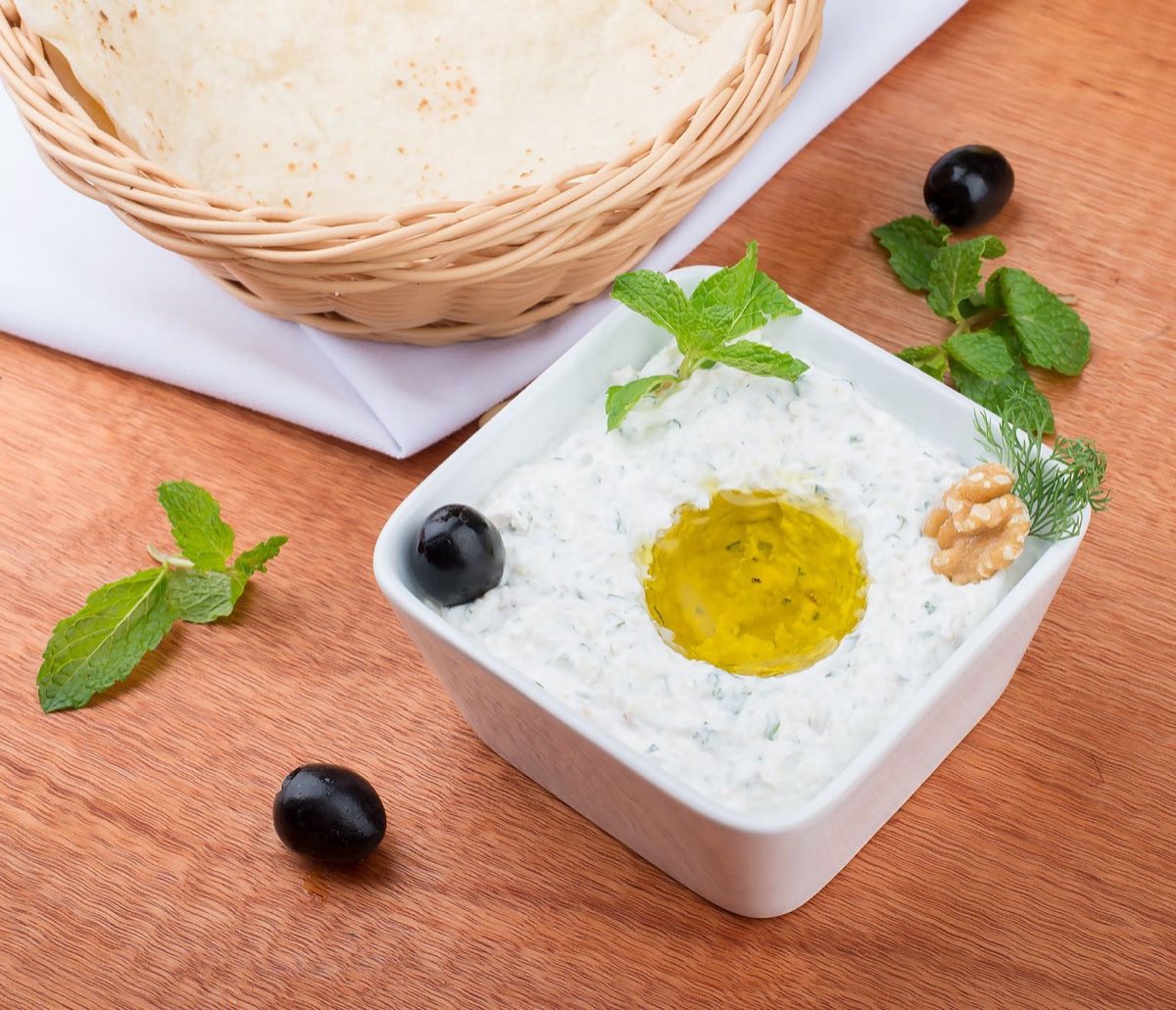 Khiyar bil Laban — Cucumber Yogurt — Crisp grated cucumber folded into thick Lebanese yogurt with dried mint and a clove of crushed garlic