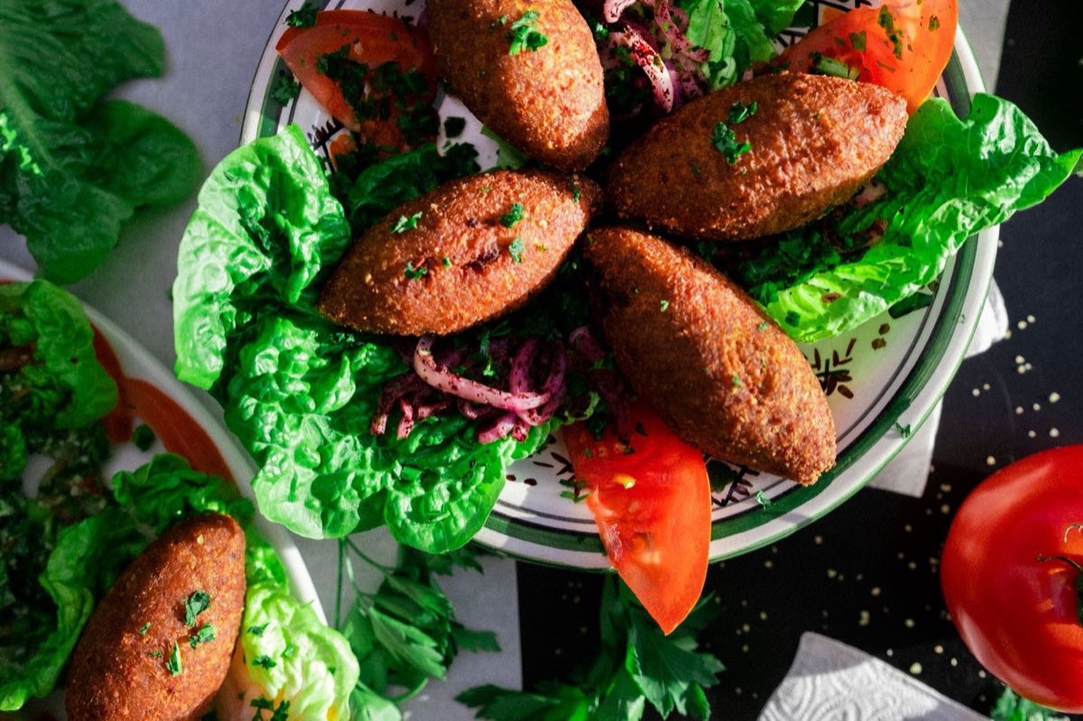 Kibbeh Aqras — Fried kibbeh balls with a crisp bulgur-and-lamb shell encasing a fragrant filling of spiced minced meat
