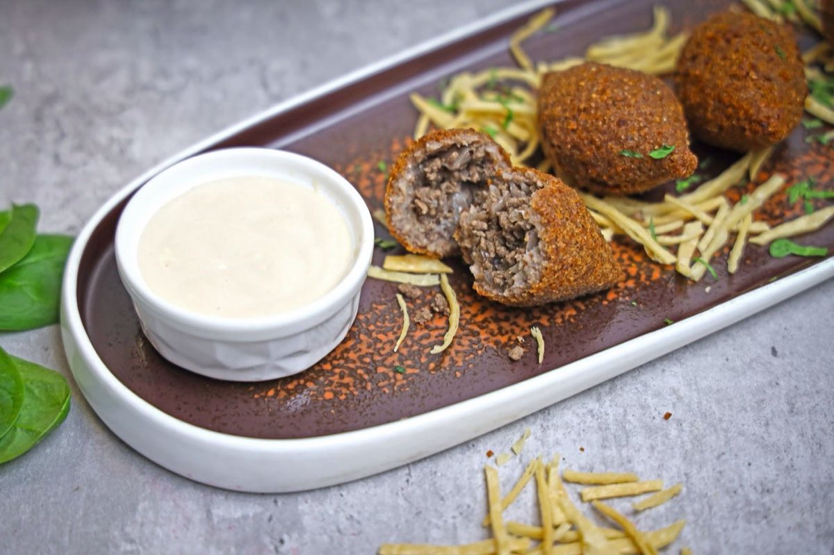 Kibbeh in Tahini and Chickpea Sauce — Kibbeh balls simmered in a thick, slightly bitter sauce of tahini and whole chickpeas with lemon