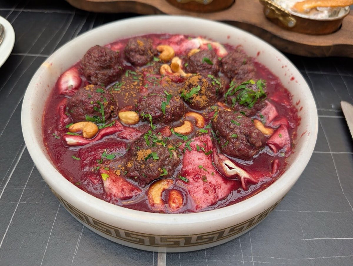 Kibbeh Halabi with Sour Cherry Sauce — The crown jewel of Idlib cooking: hollow lamb-bulgur shells stuffed with spiced minced lamb and toasted pine