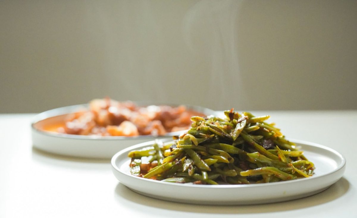 Green Beans Braised with Lamb — Green beans braised low and slow with lamb chunks and cinnamon-scented tomato sauce until the beans have