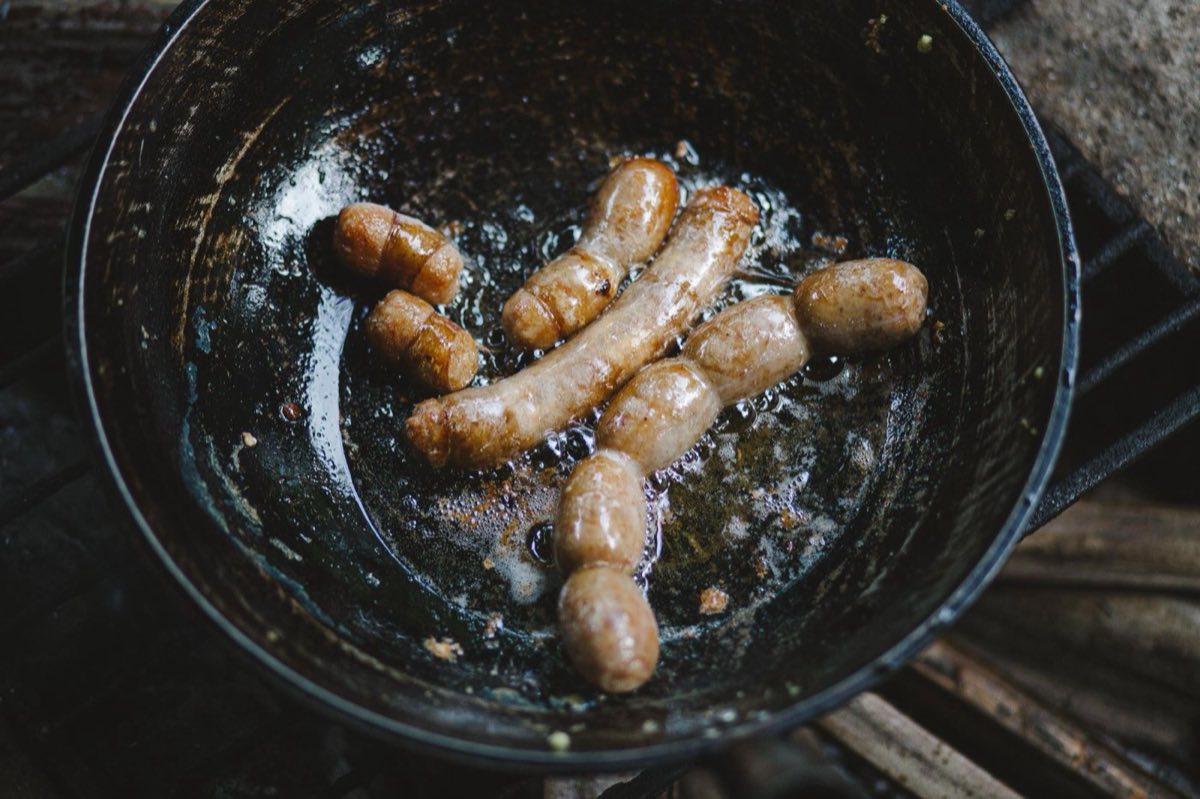 Makanek — Tiny, intensely spiced lamb sausages pan-fried in pomegranate molasses until they caramelize and blister