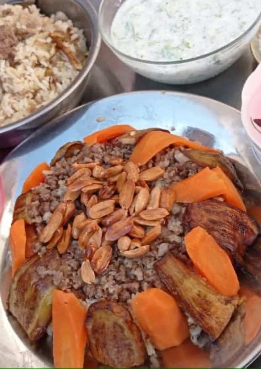 Maqluba — A theatrical one-pot wonder: layers of fried cauliflower, spiced chicken, and rice cooked together in broth