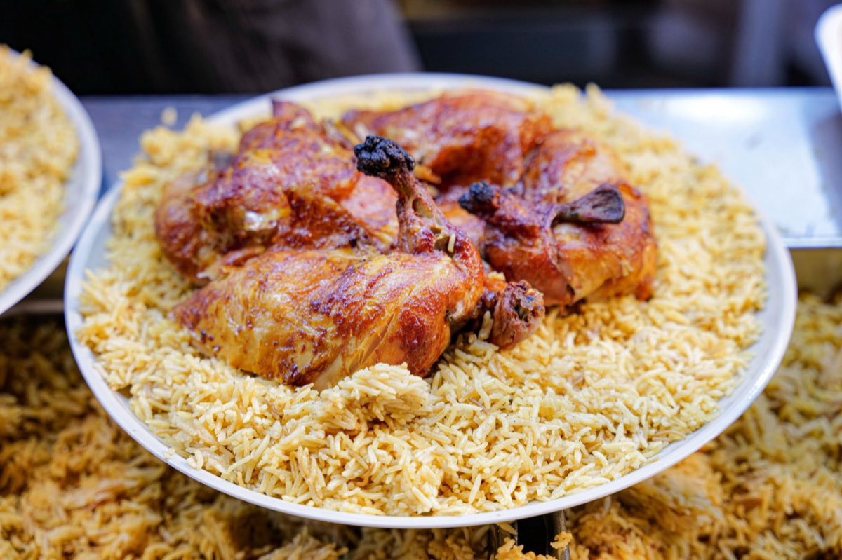 Riz 3a Djaj — A magnificent mound of spiced rice cooked in chicken broth and scattered with toasted nuts and caramelized