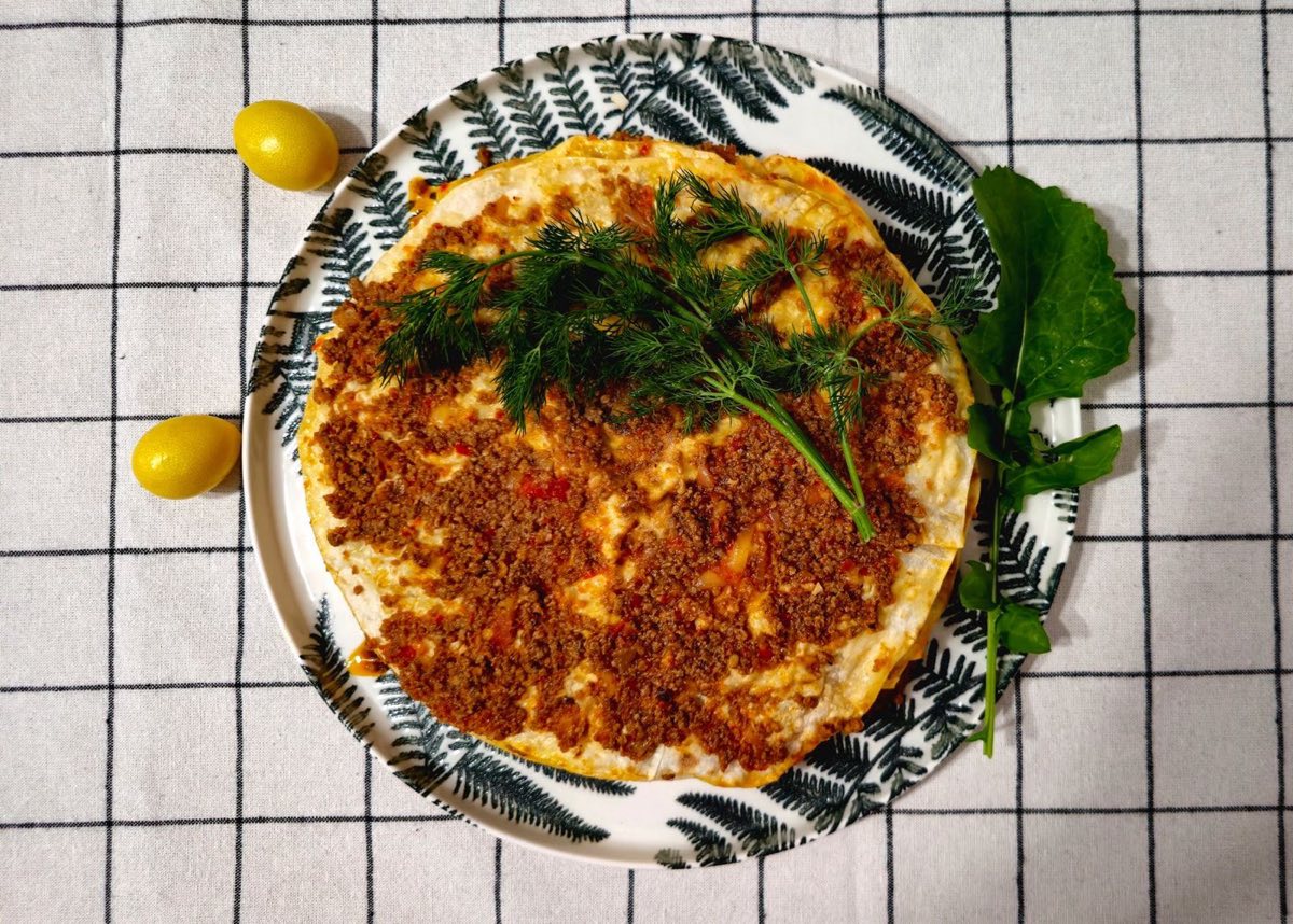 Sfiha Lahm — Small open-faced flatbreads topped with a spiced ground lamb and tomato mixture, baked at high heat until the