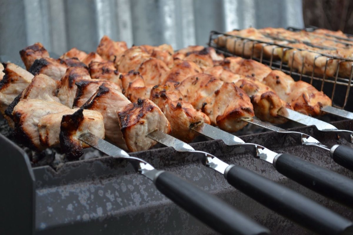 Shish Taouk — Chicken cubes marinated in a thick yogurt-garlic paste with tomato paste and lemon, threaded on skewers and